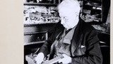 Mr Tommy Hunter, boot-maker of Redmire, Wensleydale, sharpening a knife in his workshop. Image used for one of the photographic illustrations in "Life and Tradition in the Yorkshire Dales" (1968), plate 208