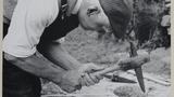 Mr Arthur Robinson, former miller of Rievaulx, dressing a millstone. Probably associated with the series of photographs used to illustrate  "Life in the Moorlands of North-East Yorkshire" (1972). Cp. plate 140. Page reference taken from the new edition, w