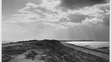 Spurn Head, showing the sea on the left, the River Humber on the right and the lighthouse in the distance. Image originally used as one of the photographic illustrations in "Getting to Know Yorkshire" (1964), plate 3, below